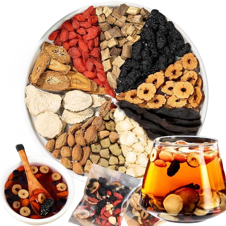 Whole botanicals in the blend arranged on a plate beside a brewed glass of amber tea