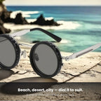 Mirage Round sunglasses on the sand by the sea